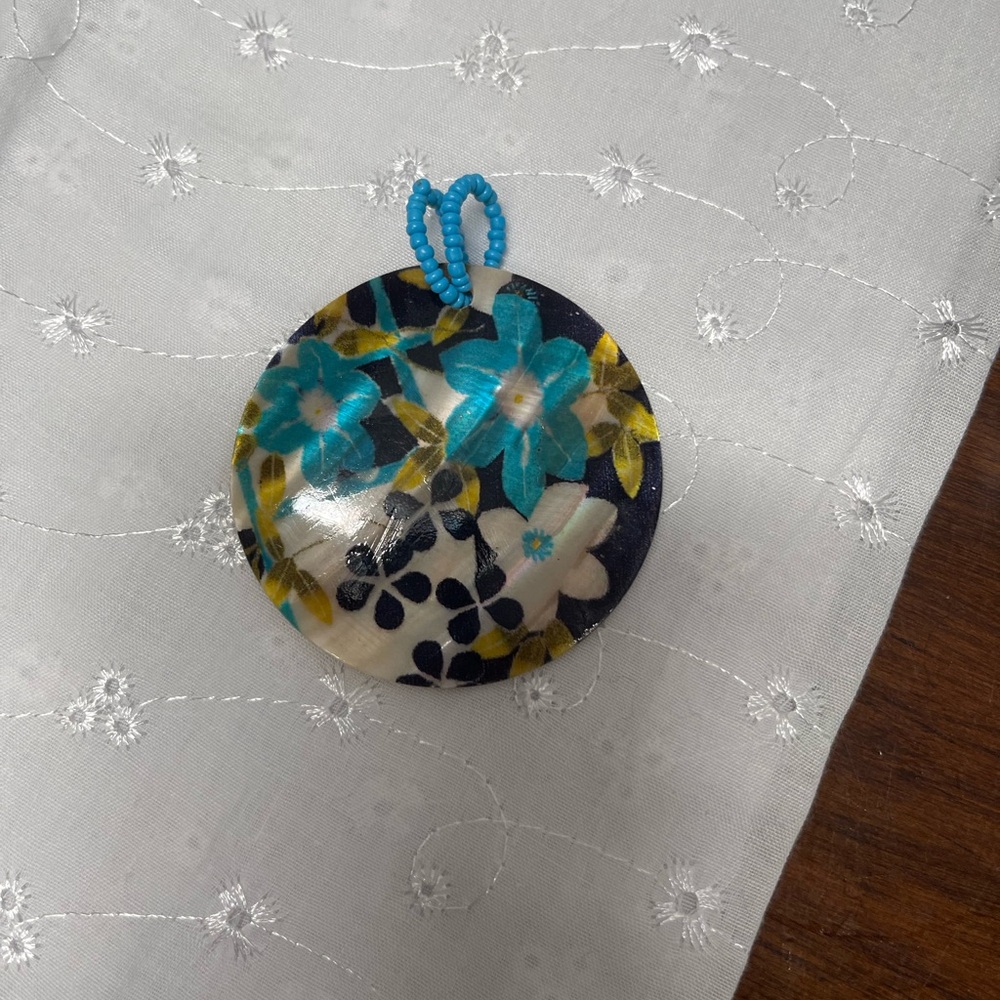 Floral Round Shell Pendant with Blue Accents